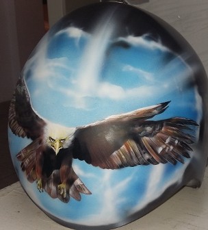 Airbrush auf einen schwarzen Helm - Ein Weißkopfadler kommt von einem Himmeldurchbruch heraus. der Adler ist in brauntönen und hat einen weißen Kop